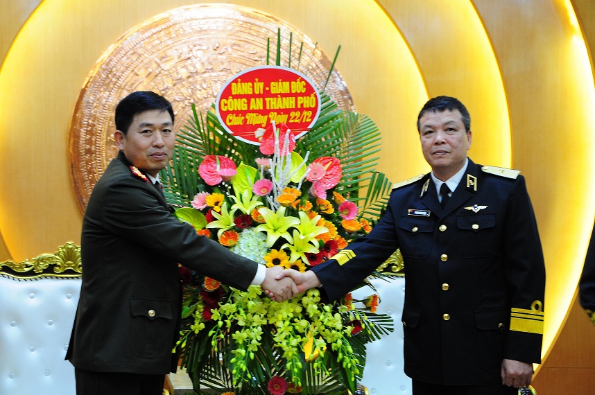 Đại tá Vũ Thanh Chương, Giám đốc CATP trao hoa chúc mừng Thiếu tướng Phạm Như Xuân, Phó Tư lệnh Bộ Tư lệnh Hải quân nhân dịp kỷ niệm 75 năm ngày thành lập QĐND Việt Nam