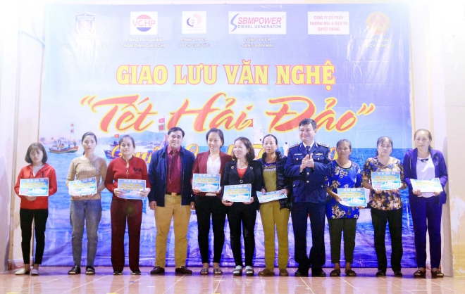 Thượng tá Lê Huy, Phó Chính ủy Bộ Tư lệnh vùng Cảnh sát biển 1 trao quà cho các gia đình chính sách trên huyện đảo Bạch Long Vĩ
